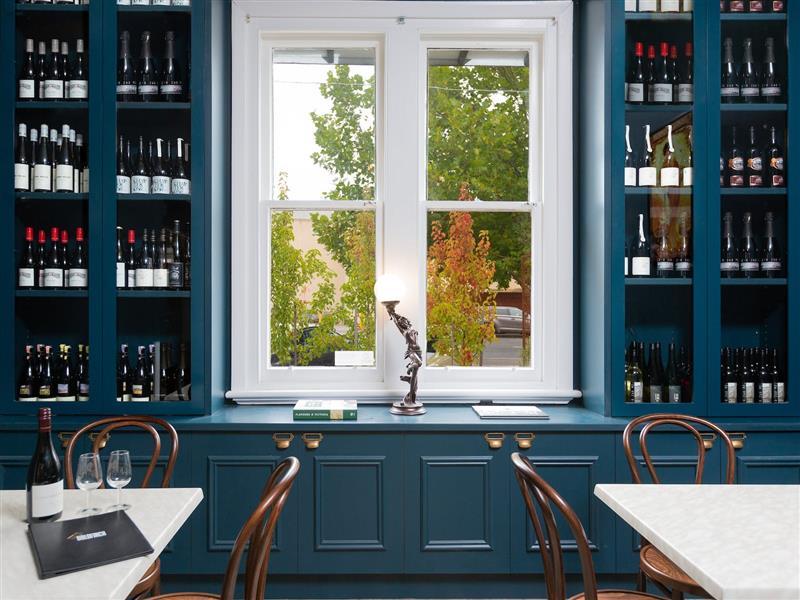 RJMs Wine bar front dining area & wine racks, looking out front windows