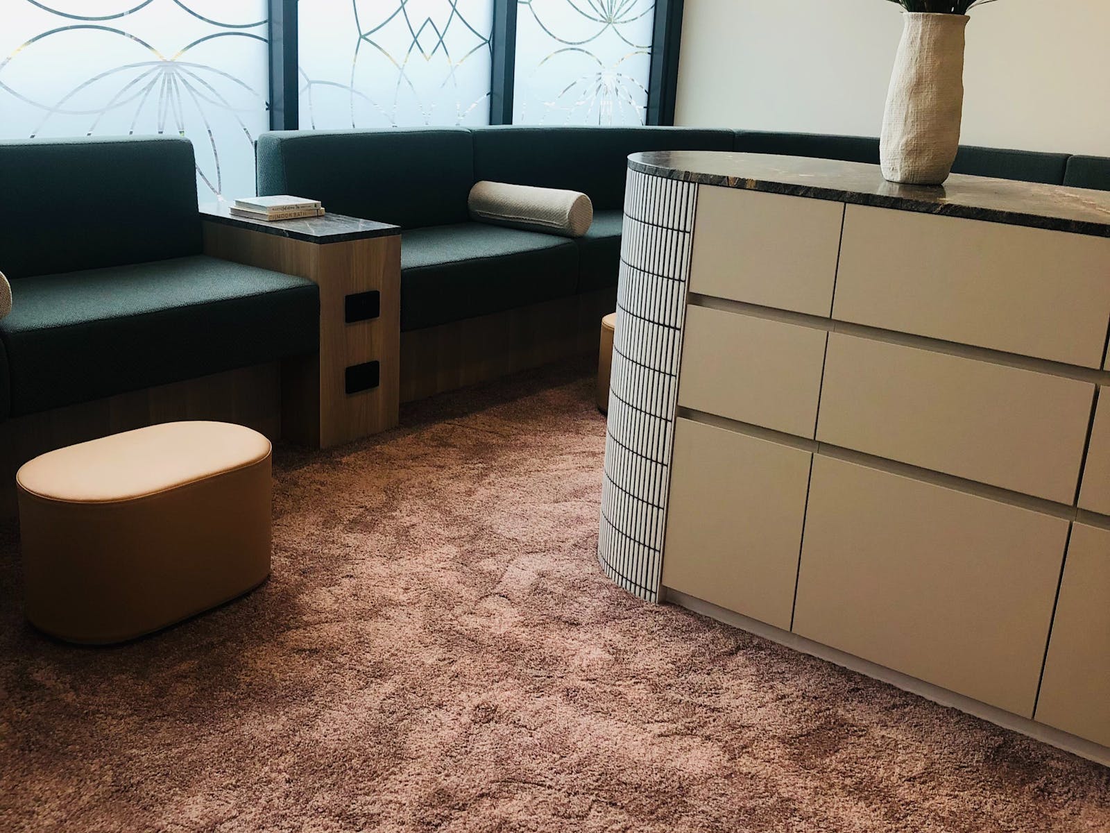 A lounge with seating, flowers, relaxing space