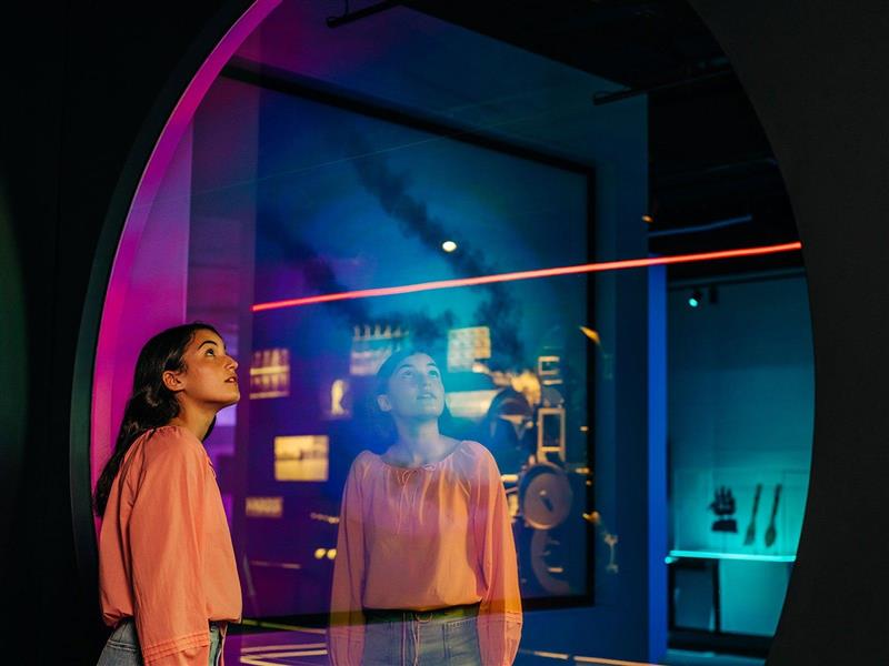 a girl looks through a circle window