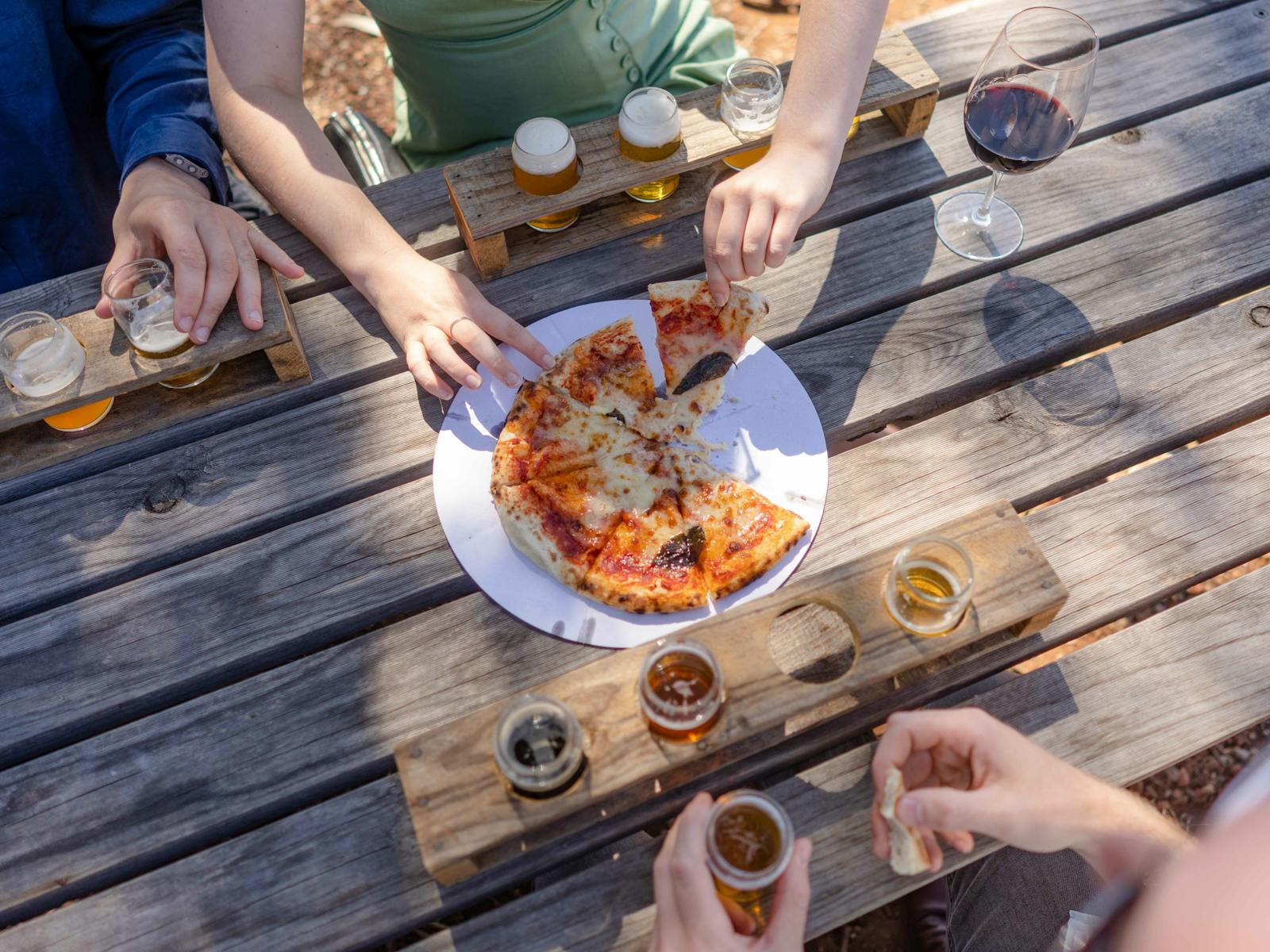 Rambling tour group enjoying stonebaked pizzas and craft beer while listening to live music